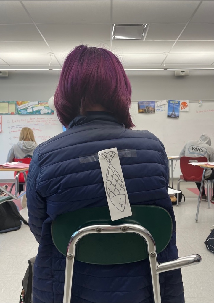 a fish on a student’s back