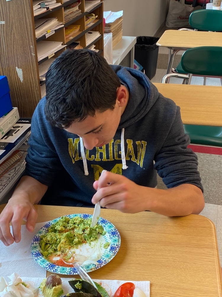 student mixing their guacamole 