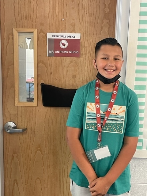 Principal for the day Anthony standing in front of his office door