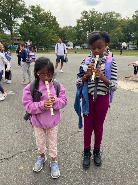 Students playing their recorders